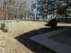 Large fenced backyard with mature trees and green space at 10128 E Troy Ave, Indianapolis, IN 46239