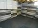 Finished basement corner with stylish wood paneling, carpet floor, and built-in shelves at 10128 E Troy Ave, Indianapolis, IN 46239