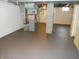 Unfinished basement with exposed ducts, concrete columns, painted concrete flooring at 10128 E Troy Ave, Indianapolis, IN 46239