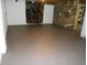 Spacious basement area with painted concrete floor, neutral walls, and deer-themed decoration at 10128 E Troy Ave, Indianapolis, IN 46239