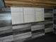 Finished basement wall with stylish wood paneling and built-in shelving at 10128 E Troy Ave, Indianapolis, IN 46239