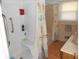 Bathroom includes shower/tub combo with patterned curtain, storage niches, and grab bar at 10128 E Troy Ave, Indianapolis, IN 46239