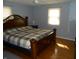Primary bedroom with a large bed, hardwood floors and natural light at 10128 E Troy Ave, Indianapolis, IN 46239