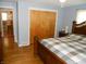 Bedroom with wood floors and a double door closet at 10128 E Troy Ave, Indianapolis, IN 46239