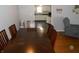 Dining room with a wooden table and access to the kitchen at 10128 E Troy Ave, Indianapolis, IN 46239