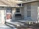 Close-up of the front entrance with stone exterior, secure doors, and seating area at 10128 E Troy Ave, Indianapolis, IN 46239