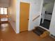 Hallway featuring wood railing on one side and steps down into another room at 10128 E Troy Ave, Indianapolis, IN 46239