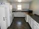 Bright kitchen with white cabinetry, modern appliances, tile backsplash and a center window view at 10128 E Troy Ave, Indianapolis, IN 46239