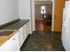 Kitchen view into dining area showcasing the kitchen's layout, cabinetry and countertop space at 10128 E Troy Ave, Indianapolis, IN 46239