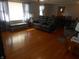 Living room with hardwood floors, bench and reclining love seat at 10128 E Troy Ave, Indianapolis, IN 46239