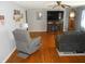 Cozy living room with recliners, hardwood floors, and a TV with a fireplace stand at 10128 E Troy Ave, Indianapolis, IN 46239