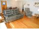 Open-concept living room and dining area with a reclining love seat at 10128 E Troy Ave, Indianapolis, IN 46239