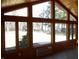 Sunroom features tile floor, wood paneled walls, and many windows looking to outside at 10128 E Troy Ave, Indianapolis, IN 46239