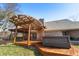 Inviting backyard featuring a wooden deck with a pergola and a relaxing hot tub at 1110 Butternut Dr, Columbus, IN 47201