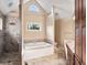Well-appointed primary bathroom with a soaking tub and custom tiled walk-in shower at 1110 Butternut Dr, Columbus, IN 47201