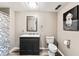 Bathroom with modern vanity, stylish mirror, shower with patterned curtain, and a toilet at 1110 Butternut Dr, Columbus, IN 47201