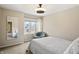 Bright bedroom featuring a chair, a window with a view, and a full-length mirror at 1110 Butternut Dr, Columbus, IN 47201