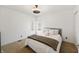 Cozy bedroom with two windows, blanket, and a decorative ceiling fan light fixture at 1110 Butternut Dr, Columbus, IN 47201