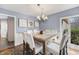Dining room featuring a modern chandelier, wainscoting, and a window offering natural light at 1110 Butternut Dr, Columbus, IN 47201