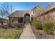 Inviting walkway leads to the brick facade home featuring an arched entryway and detailed double doors at 1110 Butternut Dr, Columbus, IN 47201