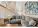 Bright living room with tall ceilings, stairs to the upper level and a comfortable sectional sofa at 1110 Butternut Dr, Columbus, IN 47201