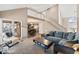 Open-concept living room with access to a deck and stairs leading to the upper level at 1110 Butternut Dr, Columbus, IN 47201