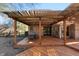 Wooden patio under pergola offers an outdoor dining and relaxing space in a private backyard at 1110 Butternut Dr, Columbus, IN 47201