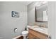 Traditional powder room features a granite countertop, wood cabinets, and updated fixtures at 1110 Butternut Dr, Columbus, IN 47201