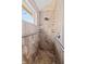 Elegant walk-in shower features designer tile, grab bars and a rainfall shower head at 1110 Butternut Dr, Columbus, IN 47201