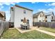 Grassy backyard showcasing a stone patio with ample seating, ideal for outdoor gatherings at 1111 Fletcher Ave, Indianapolis, IN 46203