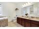 Bathroom with a double vanity, soaker tub, and tiled floor at 1111 Fletcher Ave, Indianapolis, IN 46203