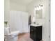 Bathroom with a classic vanity and shower featuring white shower curtain plus neutral tile at 1111 Fletcher Ave, Indianapolis, IN 46203