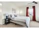 A bright bedroom is carpeted with a fan, a bed and a window at 1111 Fletcher Ave, Indianapolis, IN 46203