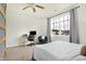 Inviting bedroom featuring a cozy chair, a modern desk, and a sliding barn door, all bathed in natural light at 1111 Fletcher Ave, Indianapolis, IN 46203