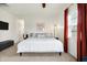 Spacious bedroom with a king bed, ceiling fan, and carpeted floors at 1111 Fletcher Ave, Indianapolis, IN 46203