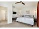 Bedroom featuring a bed, ceiling fan, carpet, and a wall-mounted TV at 1111 Fletcher Ave, Indianapolis, IN 46203
