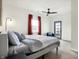 Bright bedroom with carpet, a ceiling fan, a bed, and an outdoor exit at 1111 Fletcher Ave, Indianapolis, IN 46203