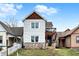Charming two-story home with stone accents and a small balcony overlooking the front yard at 1111 Fletcher Ave, Indianapolis, IN 46203