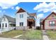 Charming two-story home with stone accents and a small balcony overlooking the front yard at 1111 Fletcher Ave, Indianapolis, IN 46203