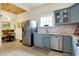 Bright eat-in kitchen with stainless appliances, farmhouse sink, and wood plank ceiling at 1111 Fletcher Ave, Indianapolis, IN 46203