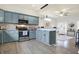 Modern kitchen with blue cabinets, stainless steel appliances, marble countertops, and hardwood floors at 1111 Fletcher Ave, Indianapolis, IN 46203