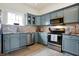 Stylish kitchen features stainless steel appliances, gray cabinets, and tile backsplash at 1111 Fletcher Ave, Indianapolis, IN 46203