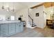 Open concept kitchen with gray cabinetry, granite countertops, and modern staircase at 1111 Fletcher Ave, Indianapolis, IN 46203
