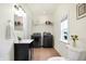 Laundry room featuring sleek black appliances, neutral tile floor, and vanity at 1111 Fletcher Ave, Indianapolis, IN 46203