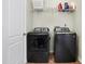 Well-equipped laundry room with modern gray washer and dryer and convenient overhead shelving at 1111 Fletcher Ave, Indianapolis, IN 46203