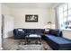 Comfortable living room with large sectional couch, area rug, and natural light at 1111 Fletcher Ave, Indianapolis, IN 46203