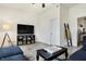 Inviting living room with sectional couch, tv, and built-in shelving at 1111 Fletcher Ave, Indianapolis, IN 46203