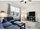 Bright living room features a sectional couch, area rug, and large windows at 1111 Fletcher Ave, Indianapolis, IN 46203
