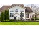 Large backyard showcases a well-manicured lawn, patio area, mature trees, and tidy landscaping at 11686 Belle Plaine Blvd, Fishers, IN 46037