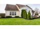 Well-maintained backyard featuring a lush lawn, manicured landscaping, and outdoor seating area for relaxation at 11686 Belle Plaine Blvd, Fishers, IN 46037